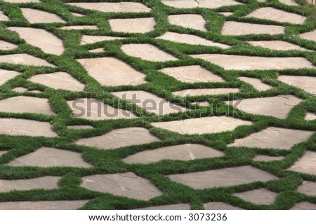 Peaceful slate tiled grass garden are. Nice image for background use