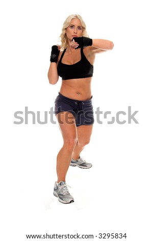 Healthy young woman in hand wraps throws a strong left elbow during a cardio boxing workout.