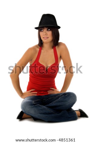 Beautiful young Asian model in red blouse and jaunty fedora sitting cross legged