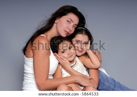 A mother and her two young daughters in a formal portrait