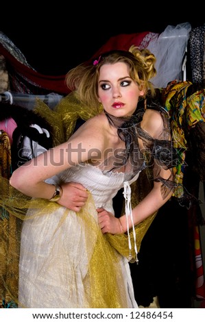 Beautiful young woman in her closet playing dress up