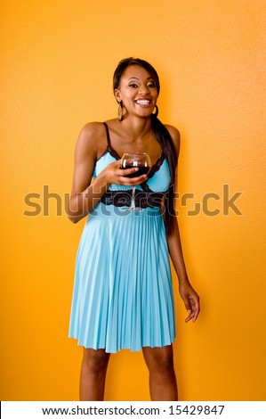 Beautiful young black woman at a party with a dirty martini in her hand