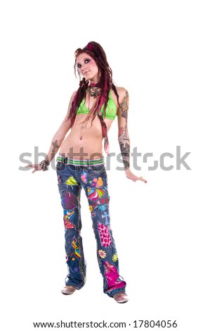 stock photo : Heavily tattooed young hippie woman in retro patchwork jeans 