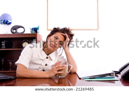 Young professional business woman struggling with working in an office early in the AM