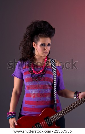 Rock and roll woman with big mohawk hair dressed in purple and pink with a red electric guitar