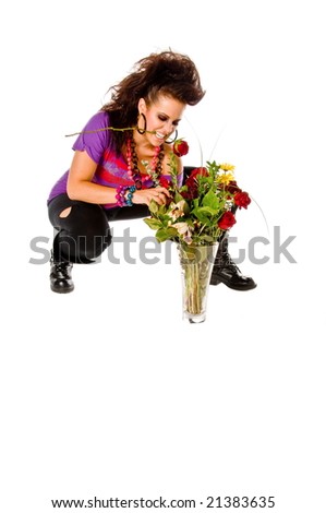 Angry young brunette woman with a vase of flowers shows how much love hurts