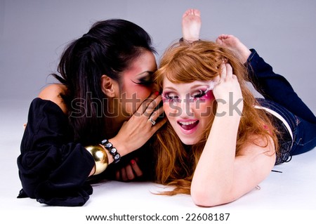 Two young women one latina with black hair one caucasian with red hair