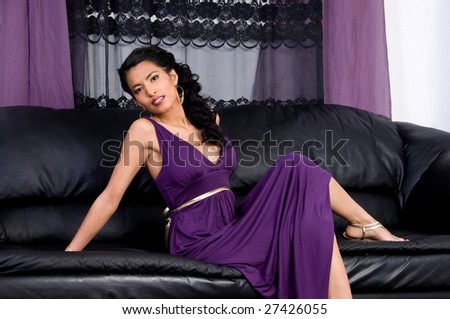 Beautiful young asian woman in a purple cocktail dress at a party