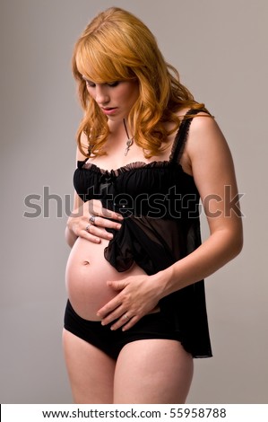 Beautiful red haired woman 8 months pregnant