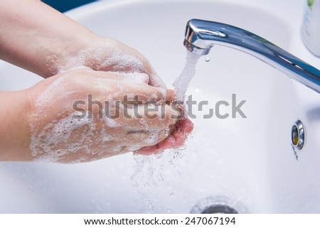 Washing of hands with soap in a bathroom
