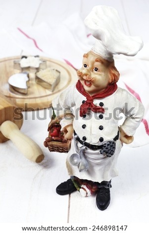 Vintage figurine: French head-cook, rolling pin, baking molds with flour and sugar