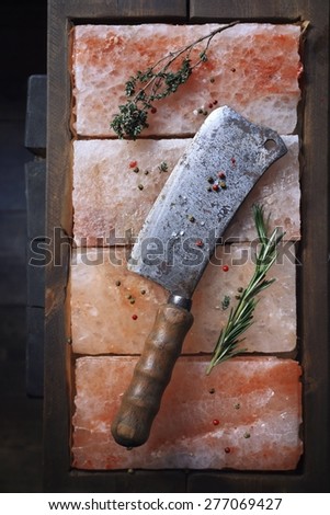 Sharp butcher knife on pink salt, seasoning