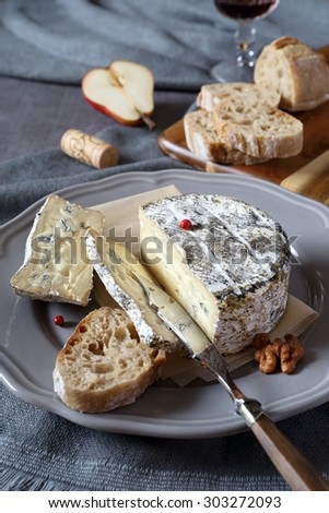 Bleu cendre, french mould cow\'s milk cheese, bread and glass of red wine