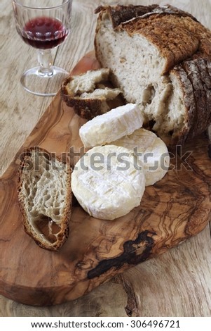 French Goat cheese, french country  bread and glass of red wine