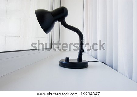 Lonely black lamp peers into the window