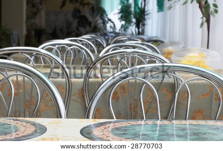 Line of metal chair hacks in dining hall