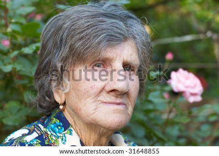 Portrait of old lady (84 years old). Outdoors