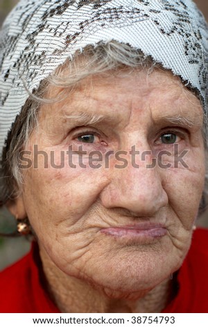 Portrait of Sad old woman in the headscarf