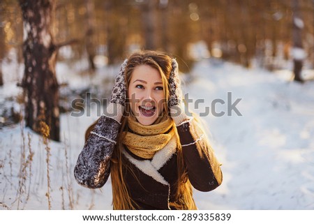 Girl in the winter forest surprised