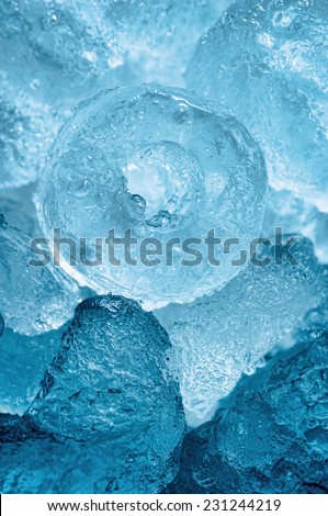 A bunch of ice cubes melting and splashed with water looking fresh and cool on acrylic surface.