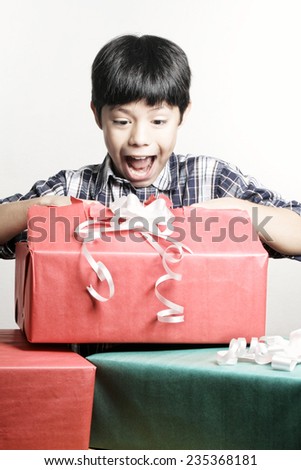 A young boy poses in the studio with many gifts and surprises