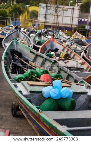 A group of traditional fishing boats parked in El Salvador, Puerto de la Libertad\'s harbor