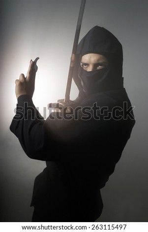 A real ninja shot on a smoke filled room and strobe light to achieve a dramatic effect.