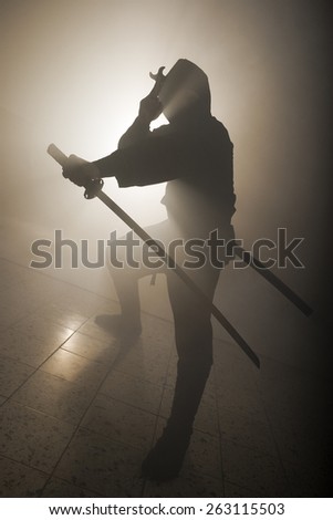 A real ninja shot on a smoke filled room and strobe light to achieve a dramatic effect.