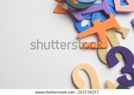Colorful numbers scattered on a white surface