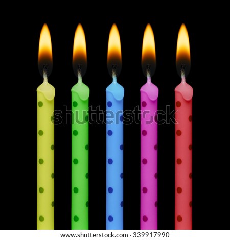 Five birthday candles isolated on black background