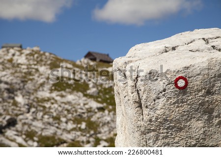 Marking sign in Julian Alps showing way to the Prehodavci mountain hut in Slovenia.