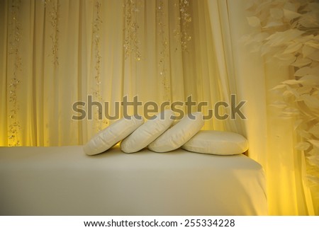 Wedding accessories. Beautiful wedding pillows on a wedding bench.