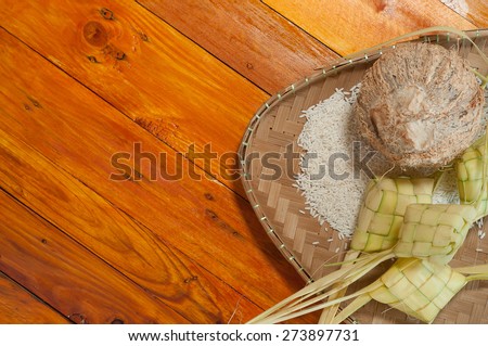 Empty ketupat or packed rice dumpling. Delicious traditional Malay ramadan or eid fitr food. Popular Malaysian food on bamboo mat and pine wood table.