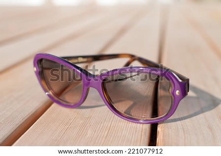 Purple sunglasses on deck