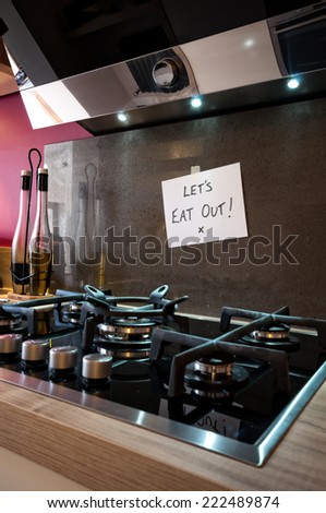 Person leaves note in kitchen  saying Let\'s Eat Out!