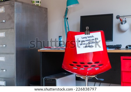 Employee leaves note pinned to chair to tell colleagues that  if they are needed, they can be found on a beach in Hawaii!