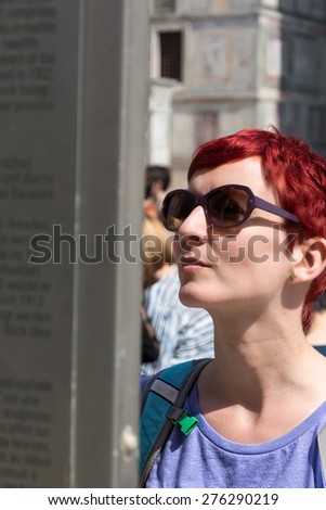 Woman reads tourist information sign