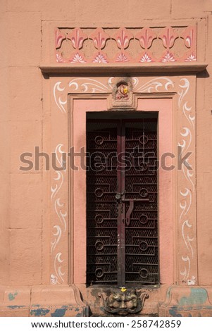 The door of Hindu temple with design and face of devil at door step indicating that person should enter the temple by suppressing one\'s devil thought and surrender to almighty