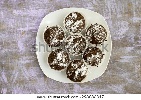 Muffins on white plate put on my blue textured kitchen table