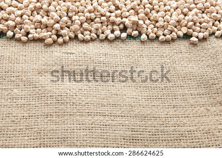 Chickpeas seen from above pouch of jute illuminated with natural light