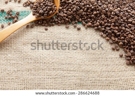 Coffee beans seen from above pouch of jute illuminated with natural light