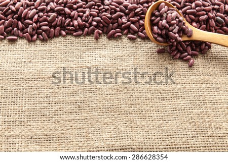 Red beans seen from above pouch of jute illuminated with natural light