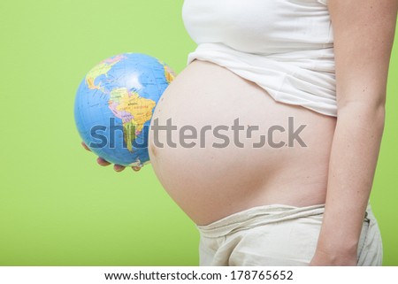 Body of pregnant woman with tummy like a globe Earth