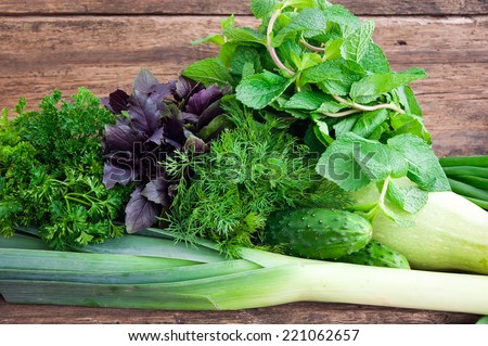 Fresh green vegetables on a wooden background
