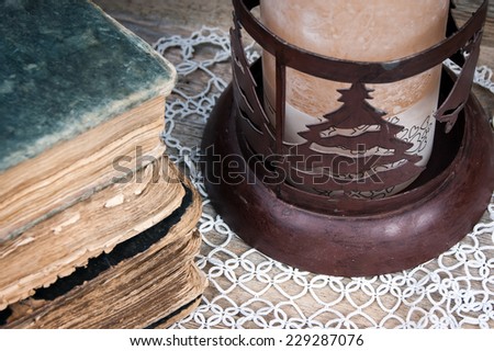 old book and a Christmas candle holder