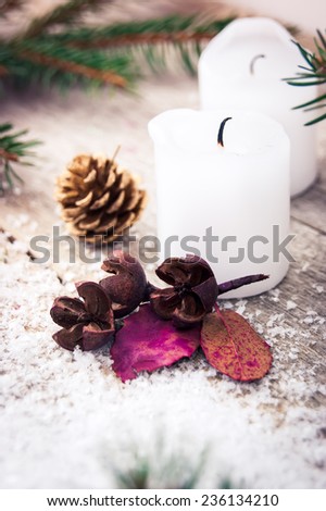 candle with dried flowers on a Christmas background