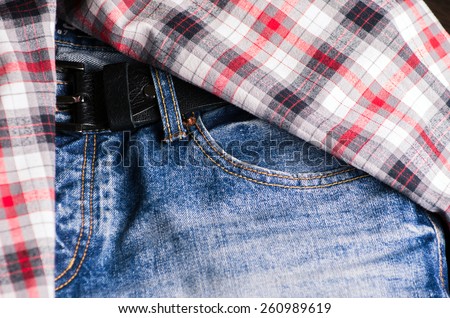 Plaid shirt and pair of jeans. Vintage stylized.