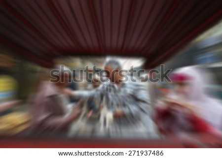 Blurry image of people at street market in India in sunny day, blur background with zooming effect in Chandni Chowk, India