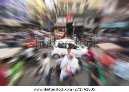 Blurry image of busy street market at Chandni Chowk, India with zooming effect
