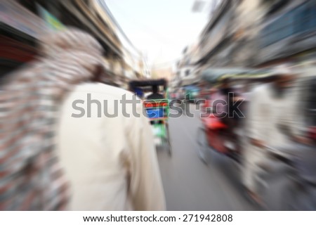 Blurry image of cycle trickshaw at India street. The cycle rickshaw is a small-scale local means of transport mainly use at India